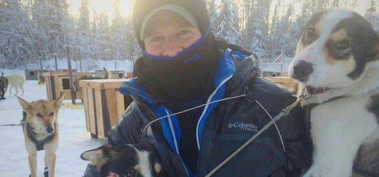 Man standing in Woolx clothing next to dogs