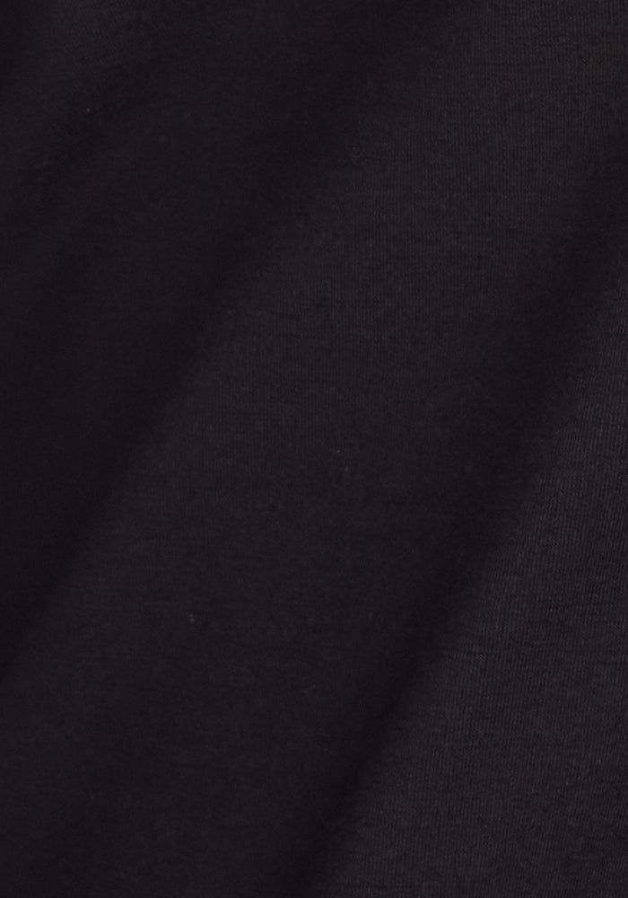 A close-up of the soft, subtly textured black fabric from Woolx Frost Tall Duralite® Leggings—perfect for crafting cozy, warm thermal leggings ideal for winter.