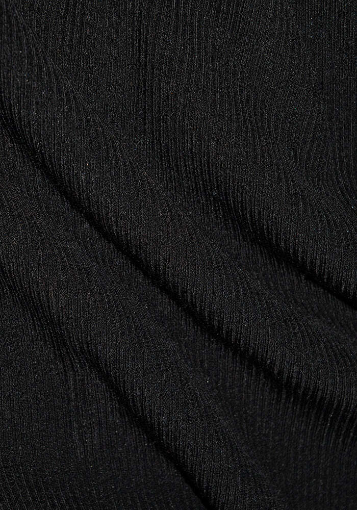 Close-up of the Vera Ribbed Tunic - Black by Woolx, showcasing soft Merino wool fabric with diagonal, textured ribbing and a fine, shimmering surface that offers natural moisture wicking.