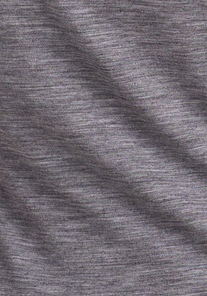 Close-up of gray heathered fabric from the Woolx Elena 3/4 Sleeve V Neck - Graphite Heather, a women's lightweight merino wool top featuring a subtle diagonal fold and fine horizontal threads.