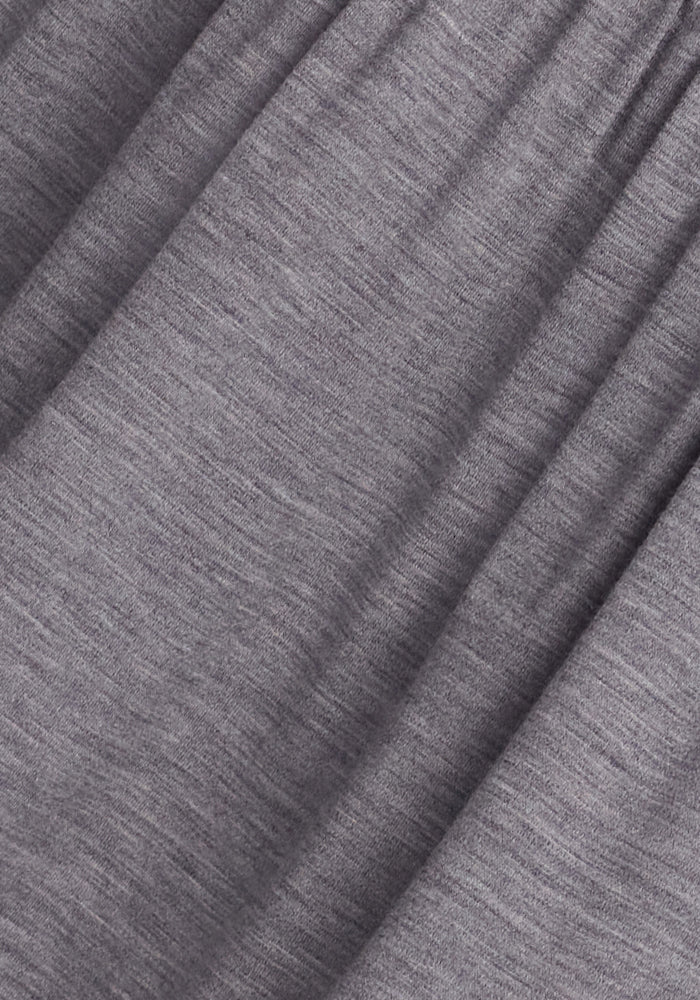 Close-up of the Marilyn Flowy Midi Skirt in Graphite Heather by Woolx, made from soft Merino wool fabric with a slightly textured surface. The material shows subtle creases and an even hue, reminiscent of an elegant A-line silhouette.