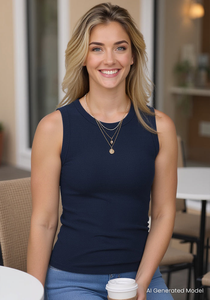 Smiling woman in a Woolx Raegan Ribbed Tank Top in Deep Navy, holding coffee at an outdoor table with blonde hair.