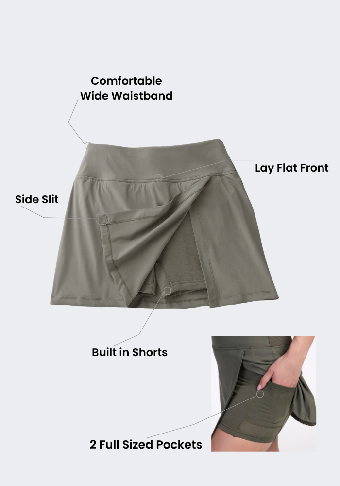 The Woolx Topanga Skort in Vintage Indigo features a wide waistband, side slit, built-in shorts, and pockets.