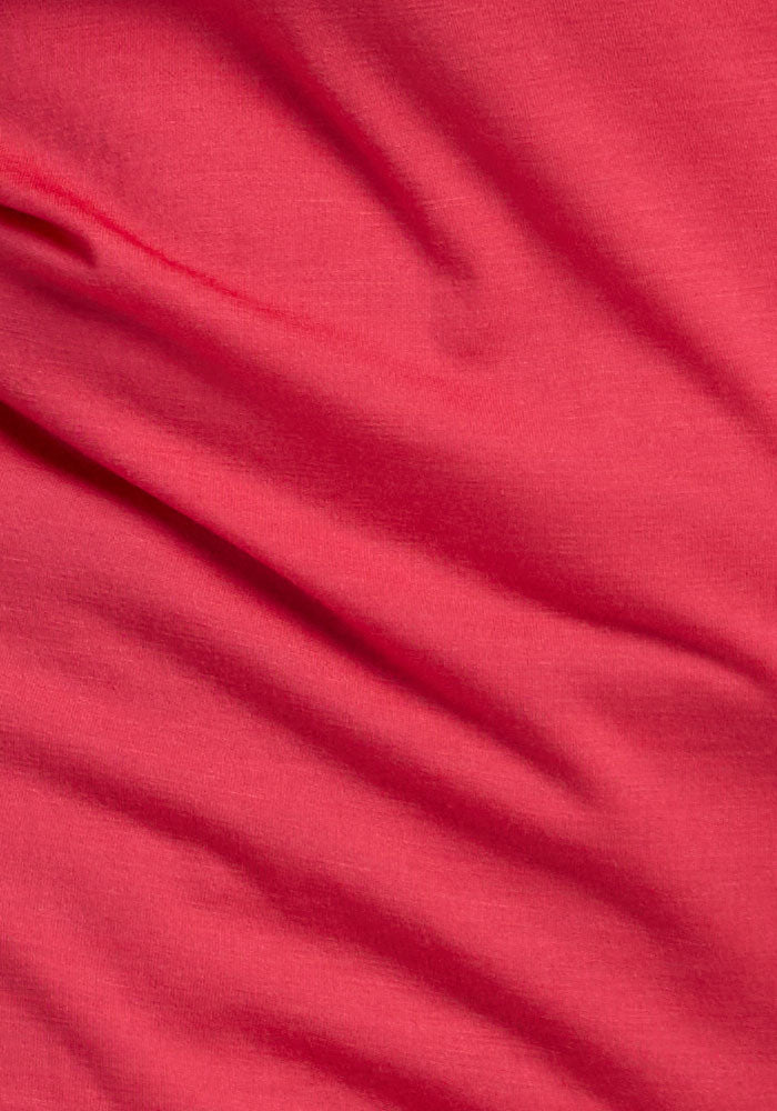 Close-up of Woolx Addie Crew Neck in Berry Ice Pop shows soft Merino wool folds and a lightweight, gentle texture.