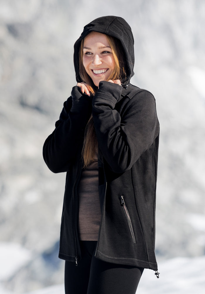 A woman wearing the Woolx Cubby Hooded Sweatshirt in black.