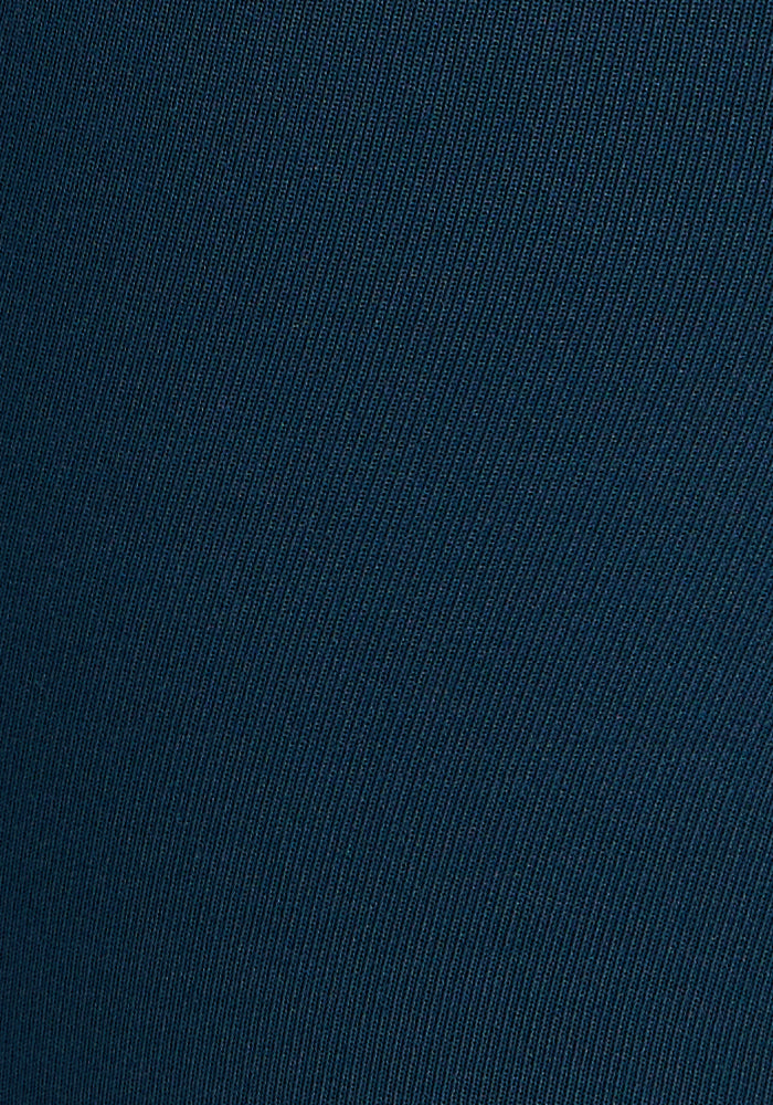 Close-up of the Merino Flex® McKenna Capris in Majolica Blue by Woolx, showing dark blue fabric with a subtle diagonal ribbed texture—ideal for high-waisted wear and featuring moisture-wicking Merino wool.