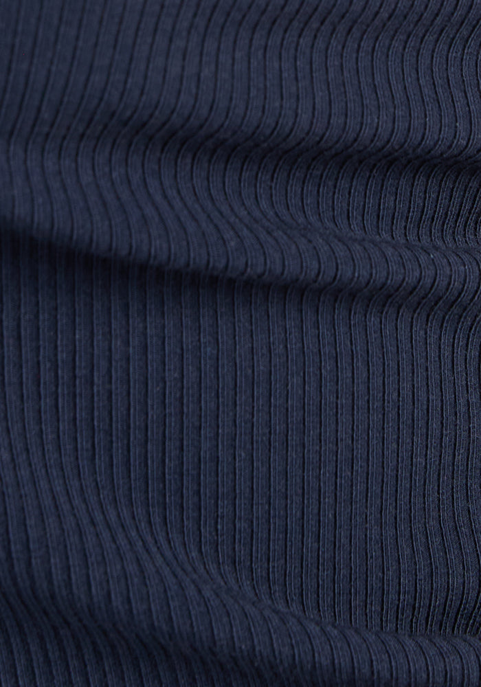 Close-up of Woolx Harlowe Ribbed Dress in Deep Navy, featuring temperature-regulating textured vertical lines.