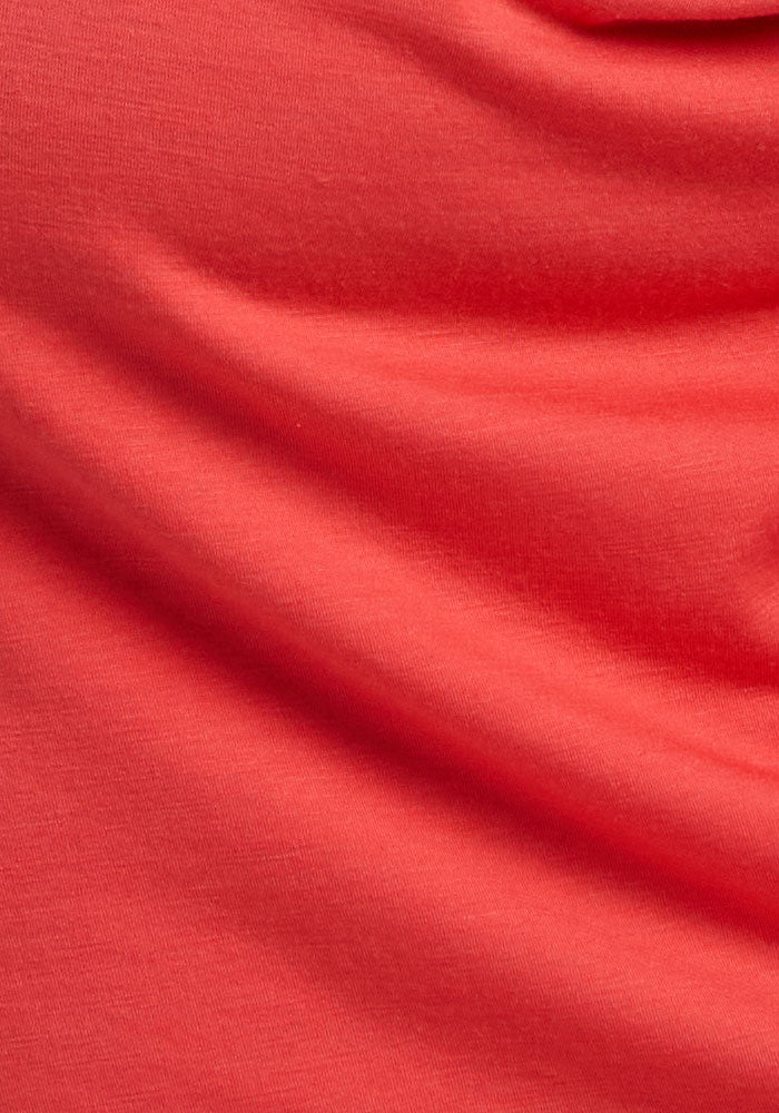 Close-up of Woolx Mia V Neck - Hibiscus fabric with soft folds and odor-resistant Merino wool texture.