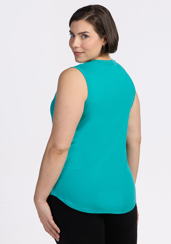Woman with short brown hair in a Woolx Bella Tunic Top • Final Sale - Cool Jade, looking over her shoulder.