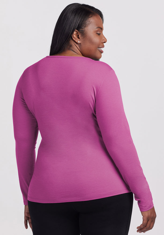 A woman wears the Woolx Remi Long Sleeve T-Shirt in Purple Wine, seen from the back against a plain background.