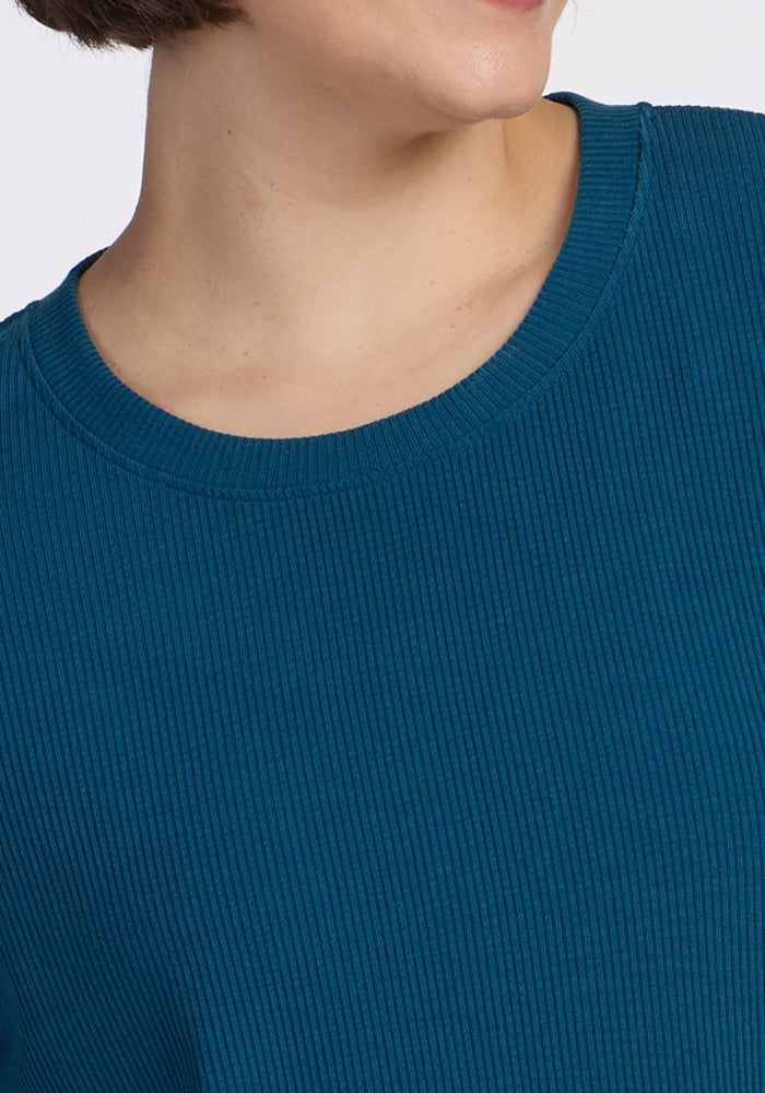 Model wears the Woolx Vera Ribbed Tunic in Moroccan Blue, shown shoulders up; face partly out of frame. Final Sale.