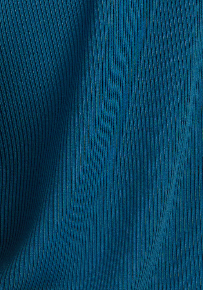 Close-up of Woolx Iris Ribbed Dress in Moroccan Blue with vertical textured lines and soft folds.