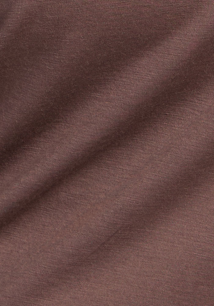 Close-up of Woolx Addie Crew Neck in Peppercorn, showing fine merino fabric texture and subtle diagonal folds.