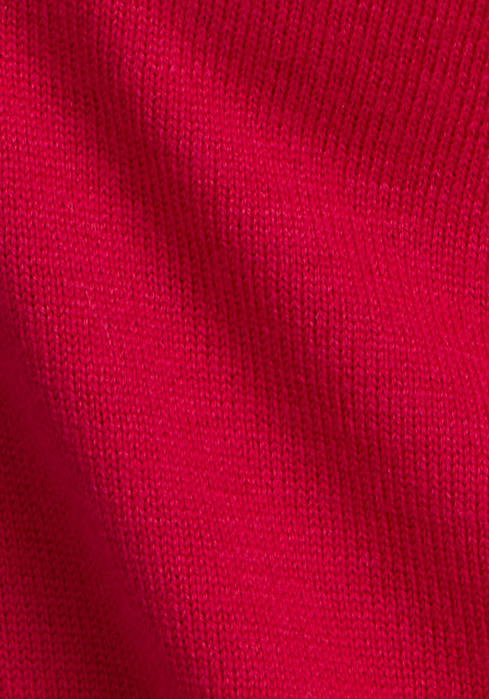 Close-up of the Woolx Chessy Tank Top in Poppy Spark, highlighting its detailed knitted texture and weave with soft shadows—a cozy sleeveless layer perfect for any season.