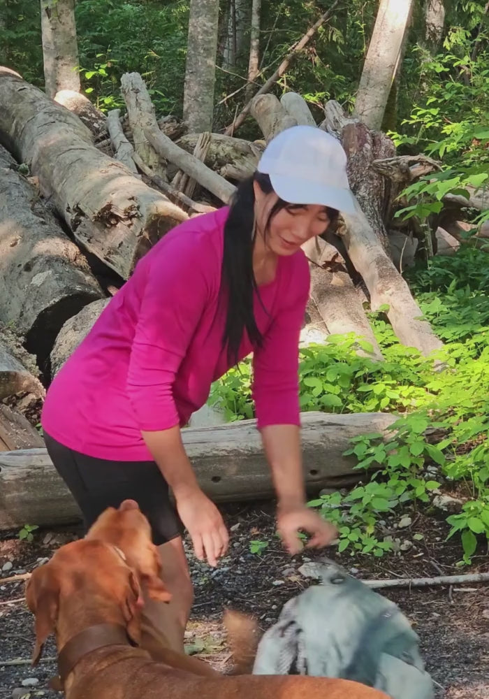 Woman wearing black Dani shorts and Elena top while walking with dog