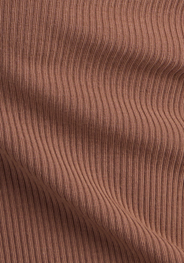 Close-up of Woolx Sloane Ribbed Tank in Sienna Kiss, showing soft, breathable merino wool and vertical ribbed texture.