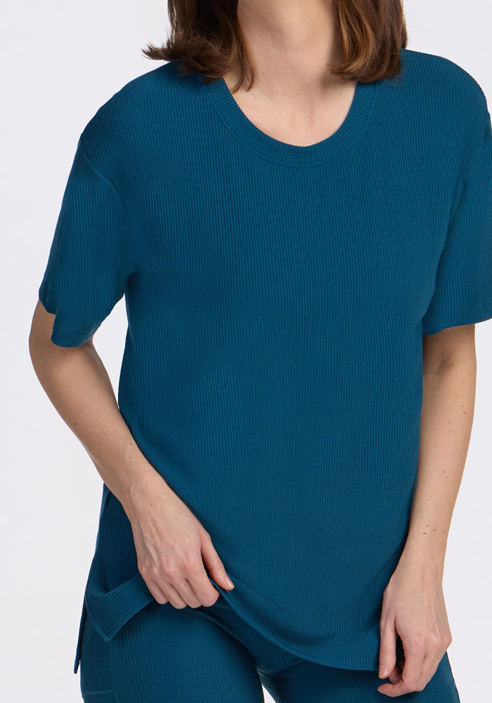 Person wearing the Woolx Vera Ribbed Tunic in Moroccan Blue, standing against a plain white background.