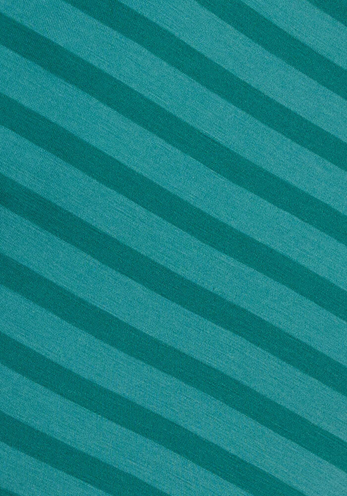 The Woolx Mia V Neck - Woodland Stripe features diagonal teal and turquoise stripes, giving this women's Merino wool tee a textured, visually dynamic look while offering odor-resistant comfort for travel.