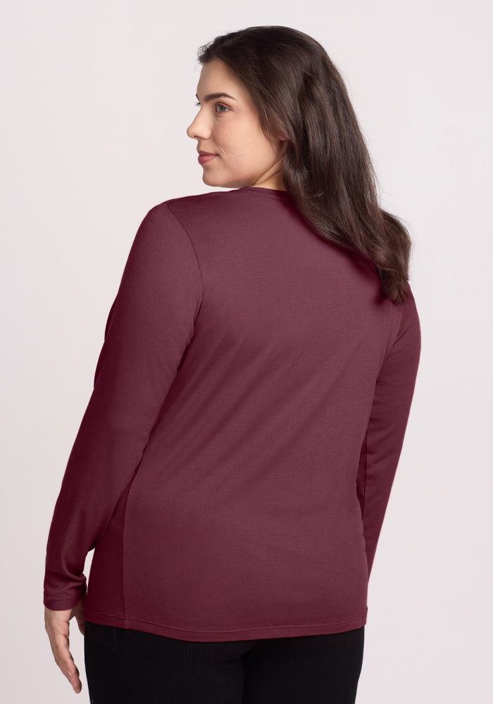 Woman with long brown hair wears the Woolx Millie Long Sleeve in Grape Harvest, shown from the back.